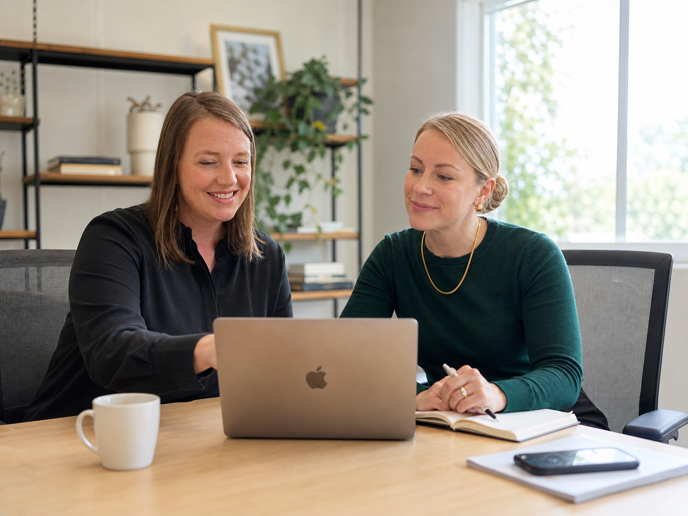 GrowthGenius founders collaborating on a laptop